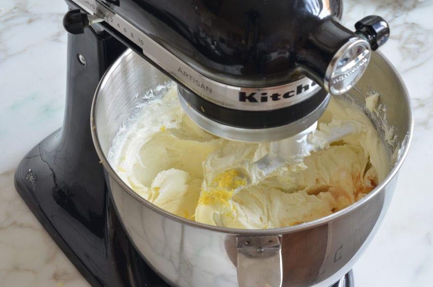 Cream cheese mixture and flavorings in a stand mixer.