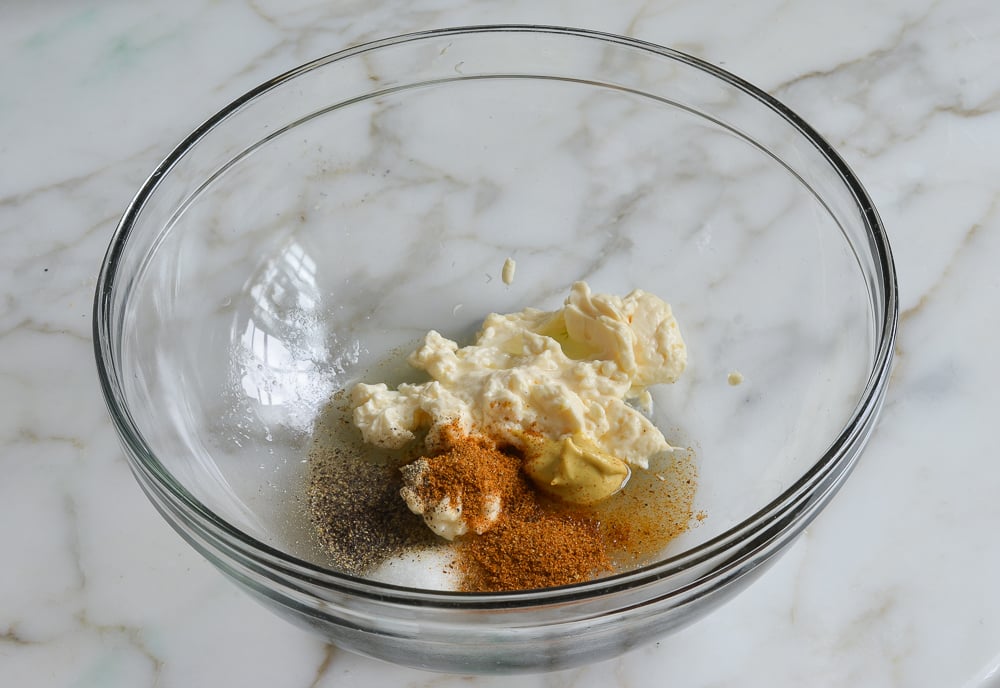 mayonnaise and seasoning in bowl for making salmon cakes