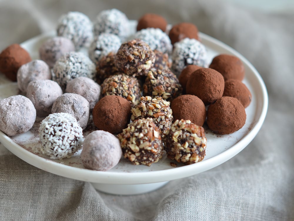 Plate of chocolate truffles with various coatings.