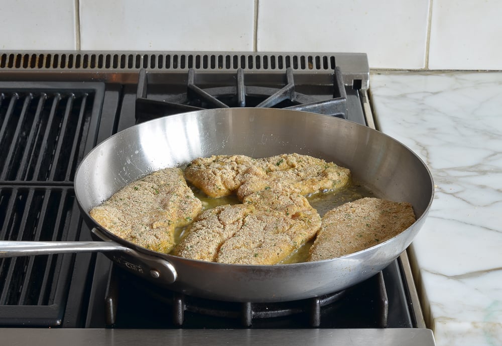 pan-frying the chicken piccata.