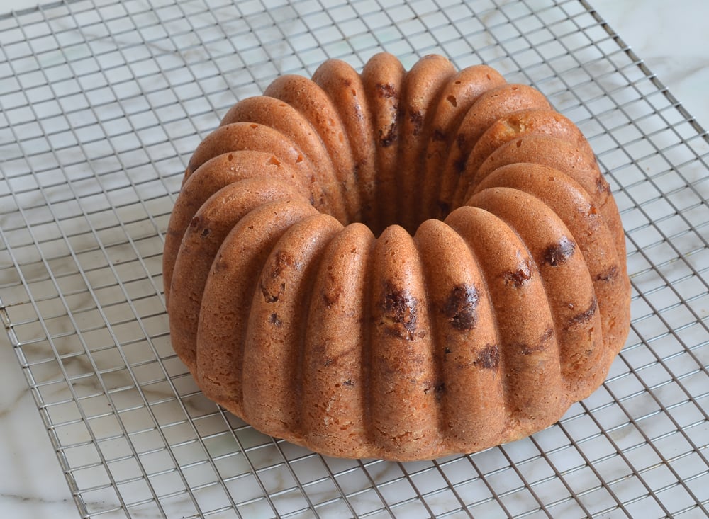 Sour cream coffee cake with cinnamon-walnut swirl on a wire rack.
