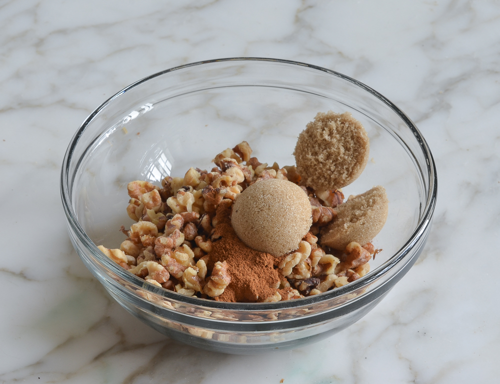 Bowl of walnuts, brown sugar, and cinnamon.