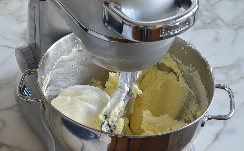 Sour cream and vanilla in a stand mixer with a butter mixture.