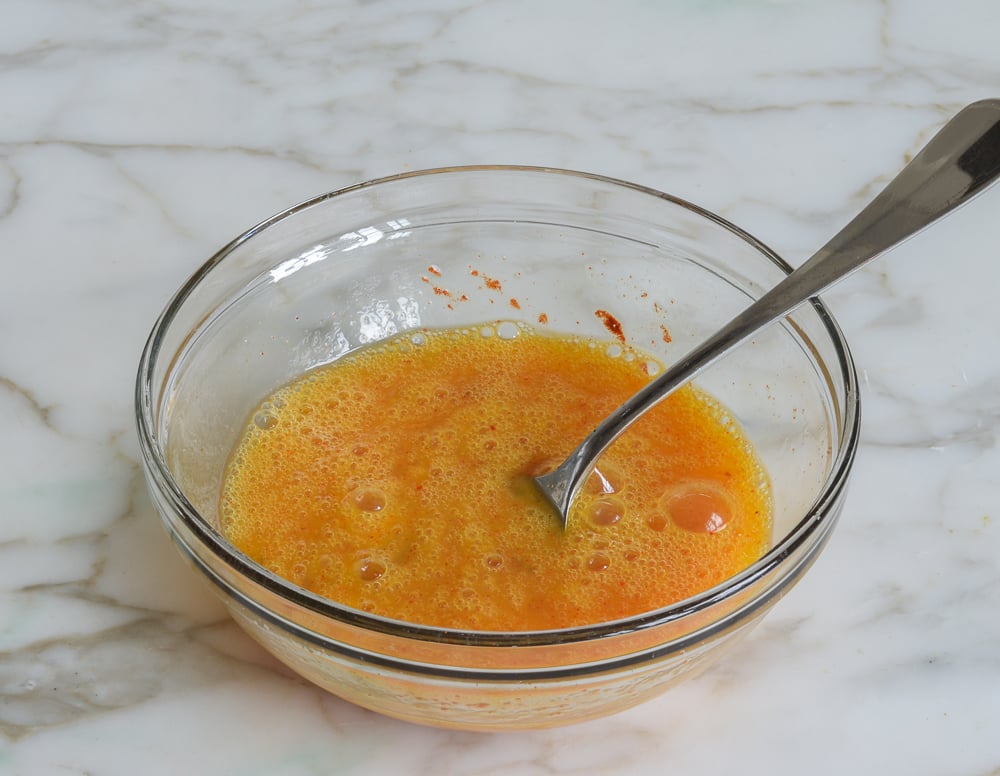 Beaten eggs in a bowl.