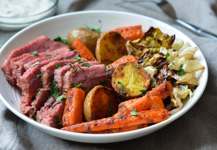 corned beef and cabbage in bowl with horseradish cream sauce on side