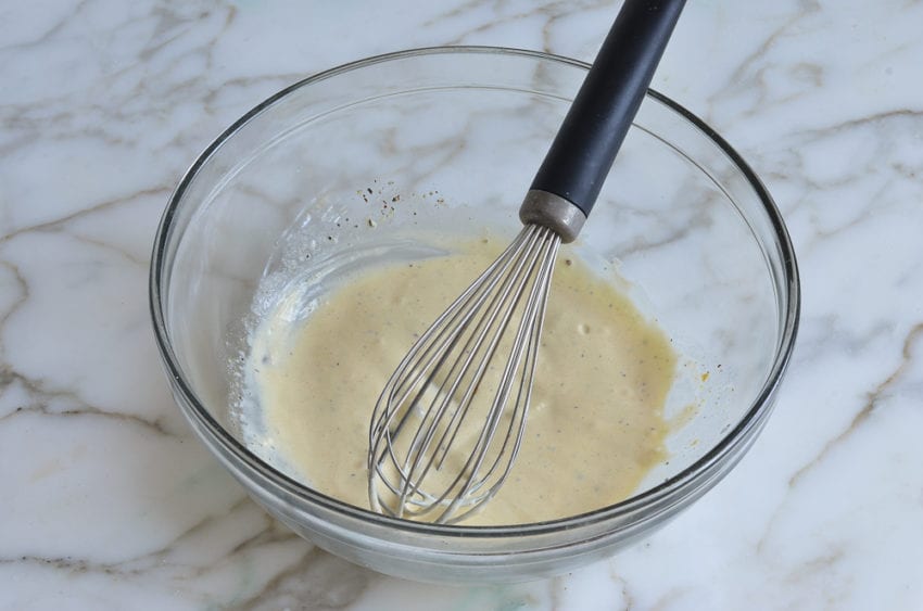whisked dressing in mixing bowl