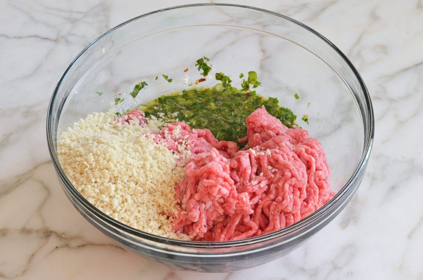 Ground meat and panko added to a bowl of egg mixture.