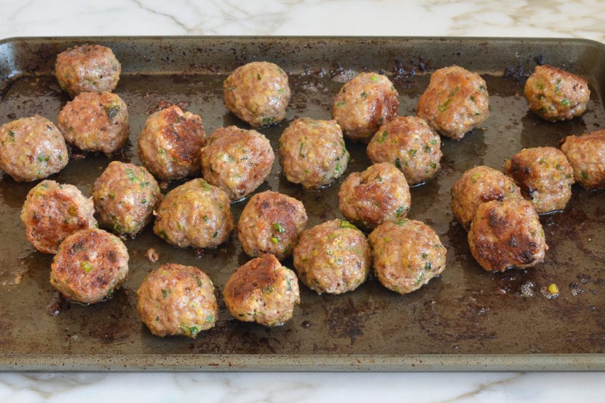 Baking tray of meatballs.