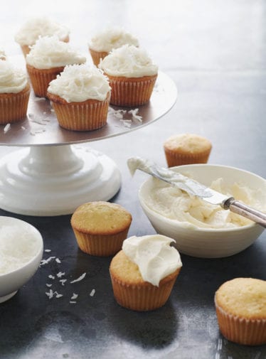 Coconut Cupcakes on a cake platter.