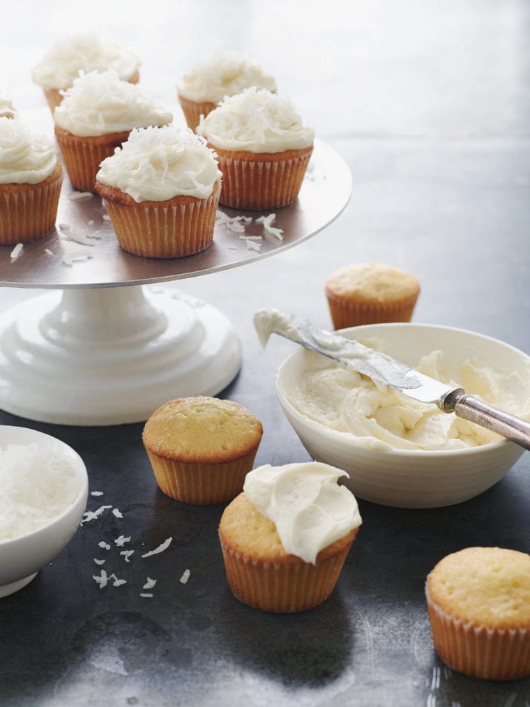 Coconut Cupcakes on a cake platter.