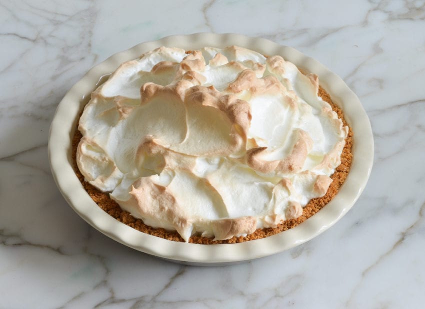 Baked lemon meringue pie in a pie pan.