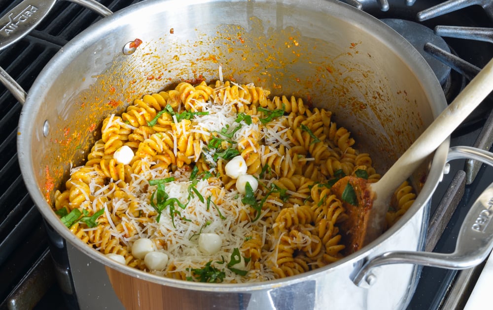 Pasta with sun-dried tomato pesto in a pot.