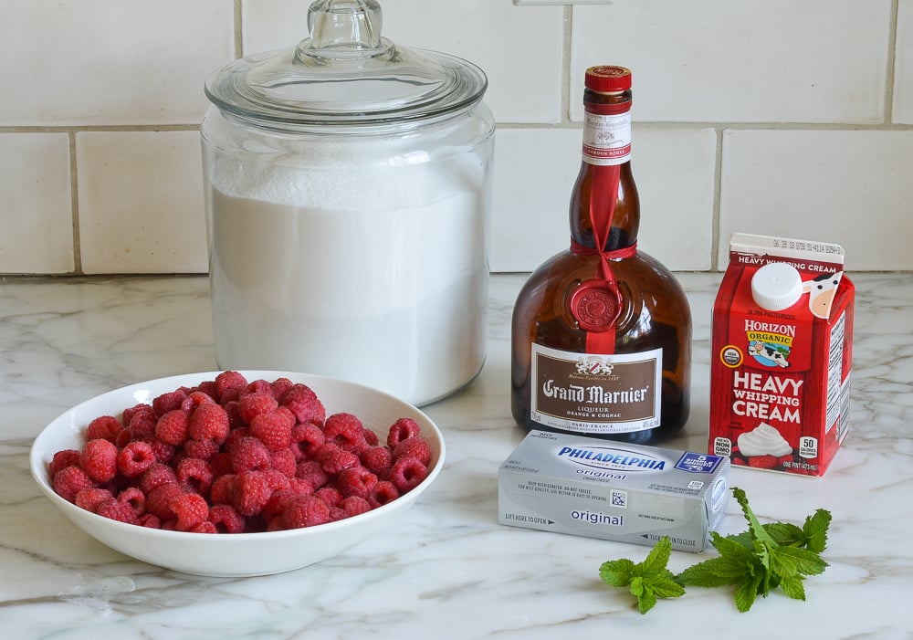 Parfait ingredients including cream cheese, raspberries, and heavy cream.