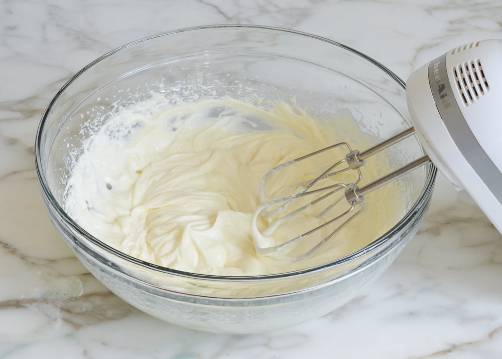Heavy cream and cream cheese mixture in a bowl.