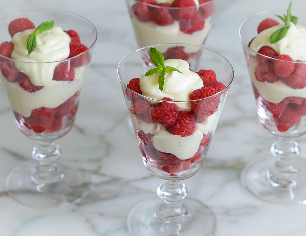 Raspberry Parfaits in stemmed glasses.