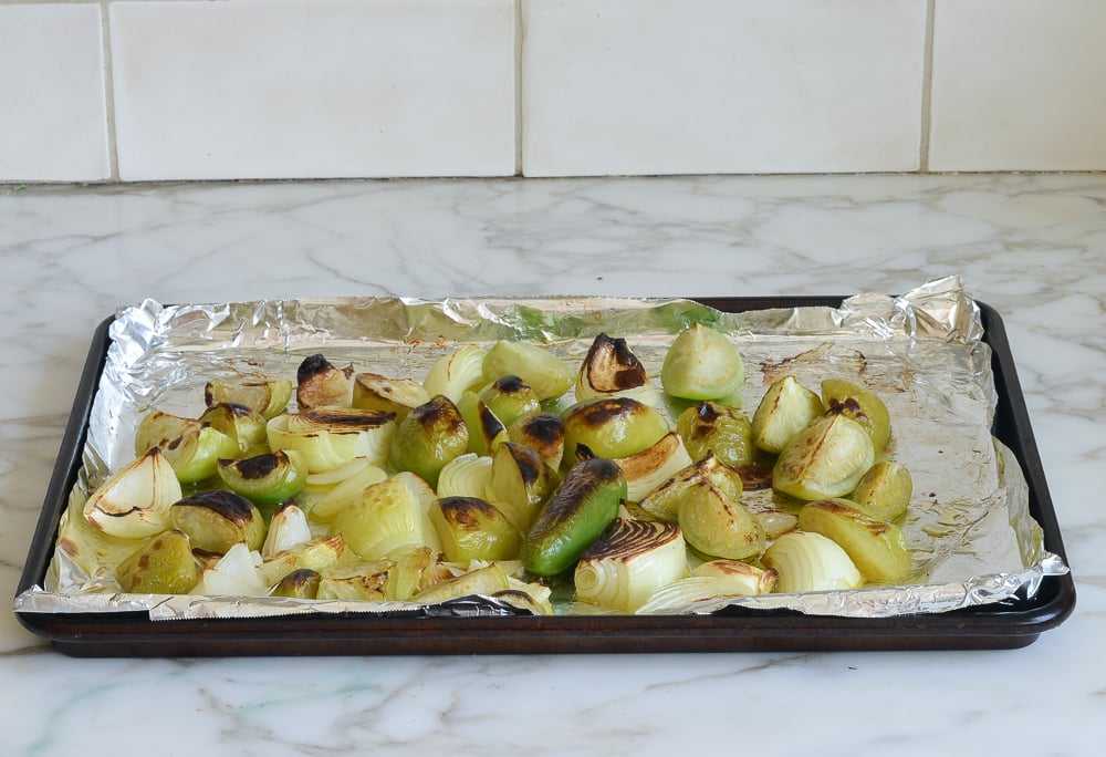 Lined baking sheet of roasted vegetables.