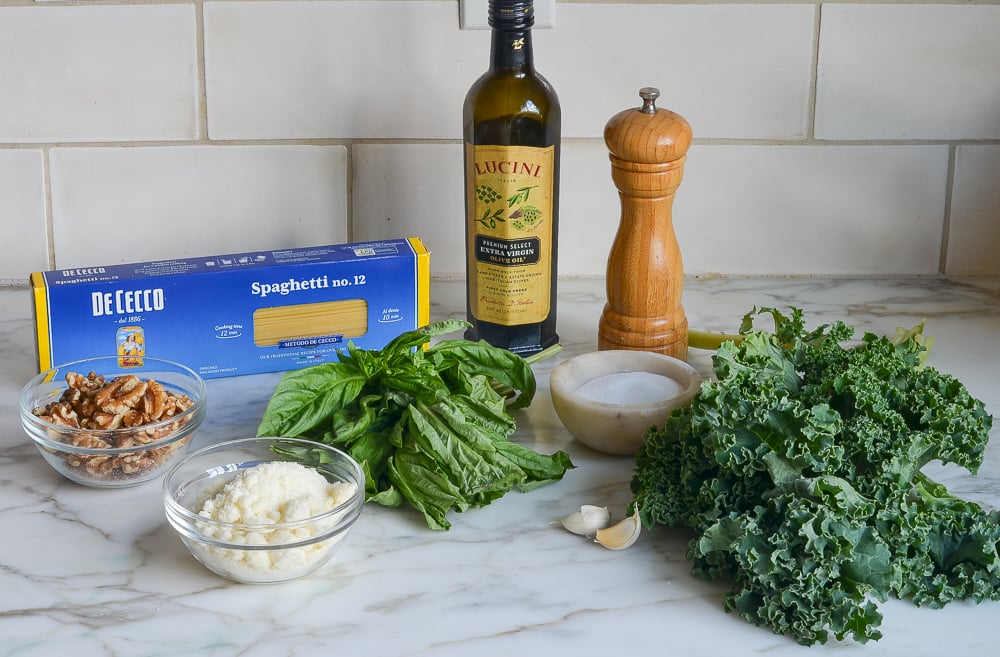 Spaghetti ingredients including olive oil, kale, and garlic.