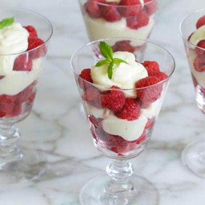 Raspberry Parfaits in stemmed glasses.