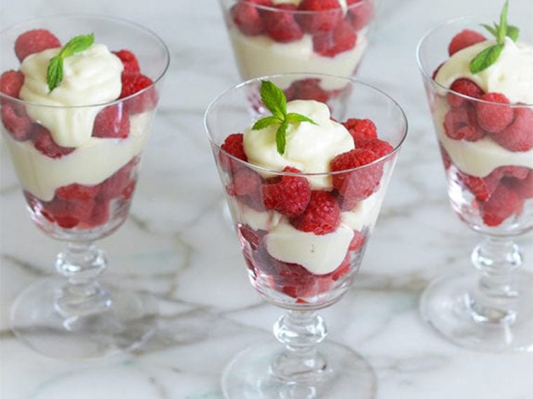 Raspberry Parfaits in stemmed glasses.