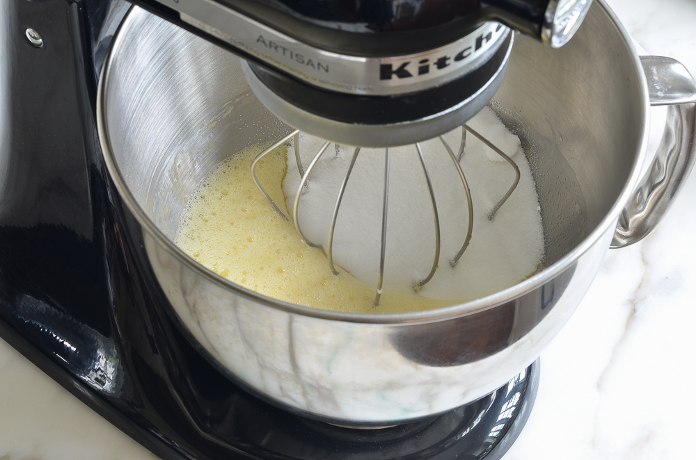 Sugar in a stand mixer with eggs.