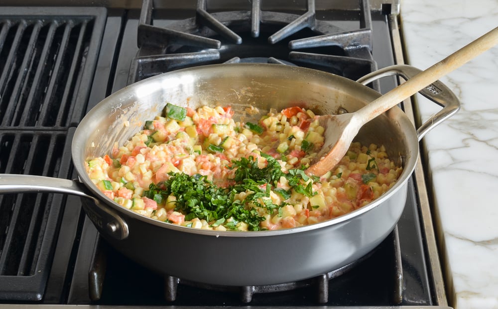 Basil in a skillet with vegetables.