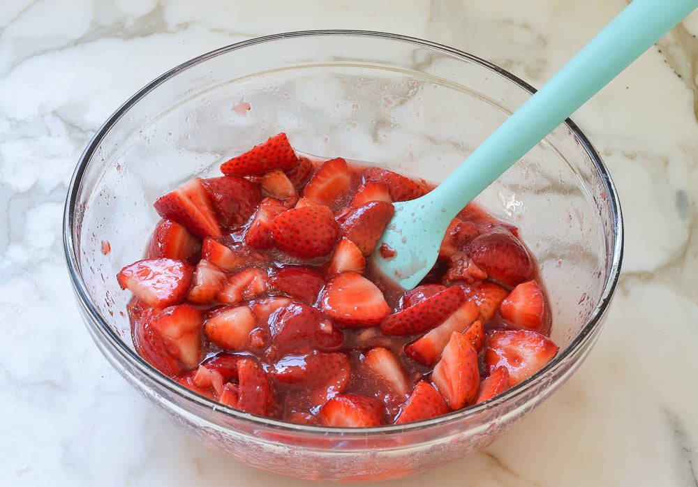 Spatula in a fruit and sugar mixture.