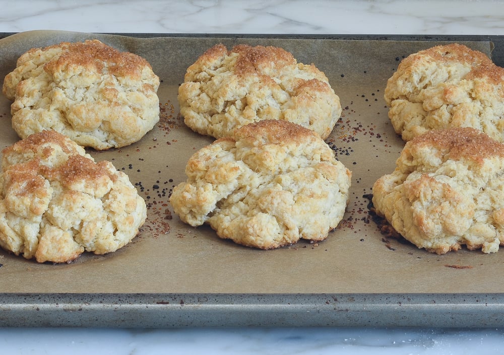 Shortcakes on a lined baking sheet.