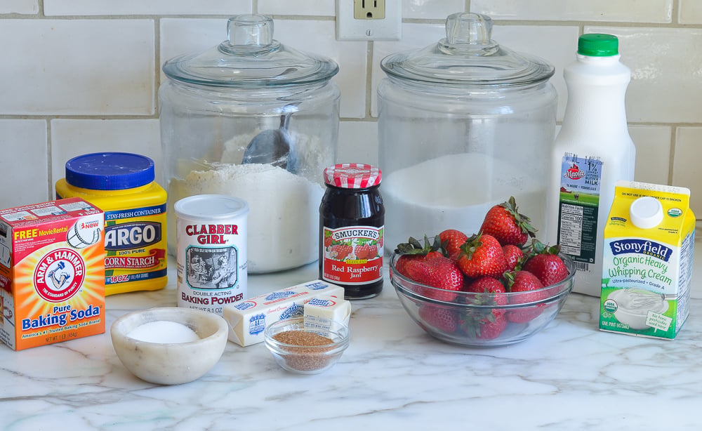 Strawberry shortcake ingredients including baking powder, baking soda, and cornstarch on the countertop.