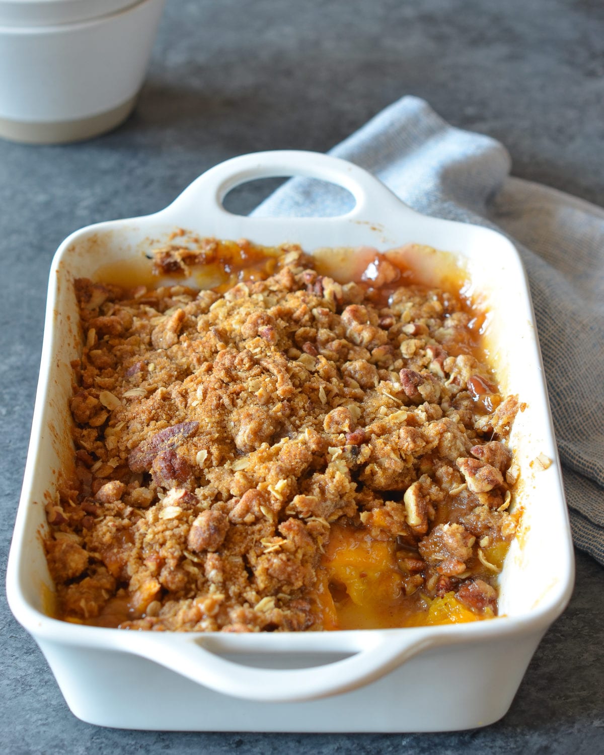 Partially-served Peach Crisp in a baking dish.