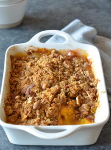 Partially-served Peach Crisp in a baking dish.
