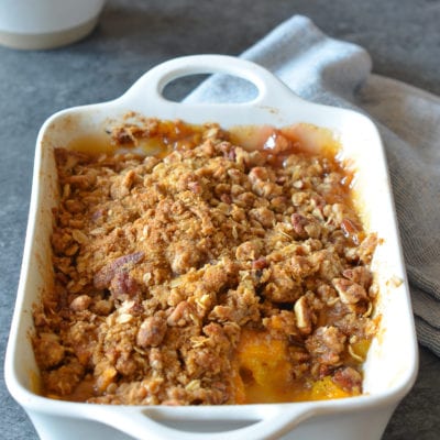 Partially-served Peach Crisp in a baking dish.