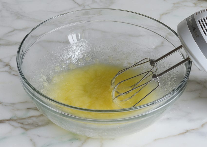 Electric mixer with a bowl of butter and sugar.
