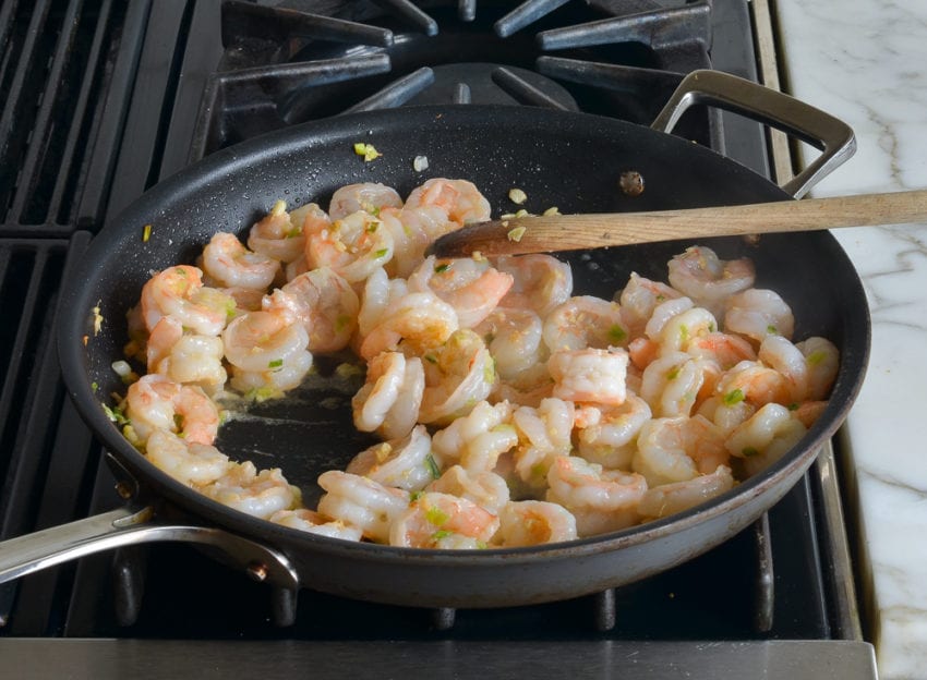 Skillet of cooked shrimp.