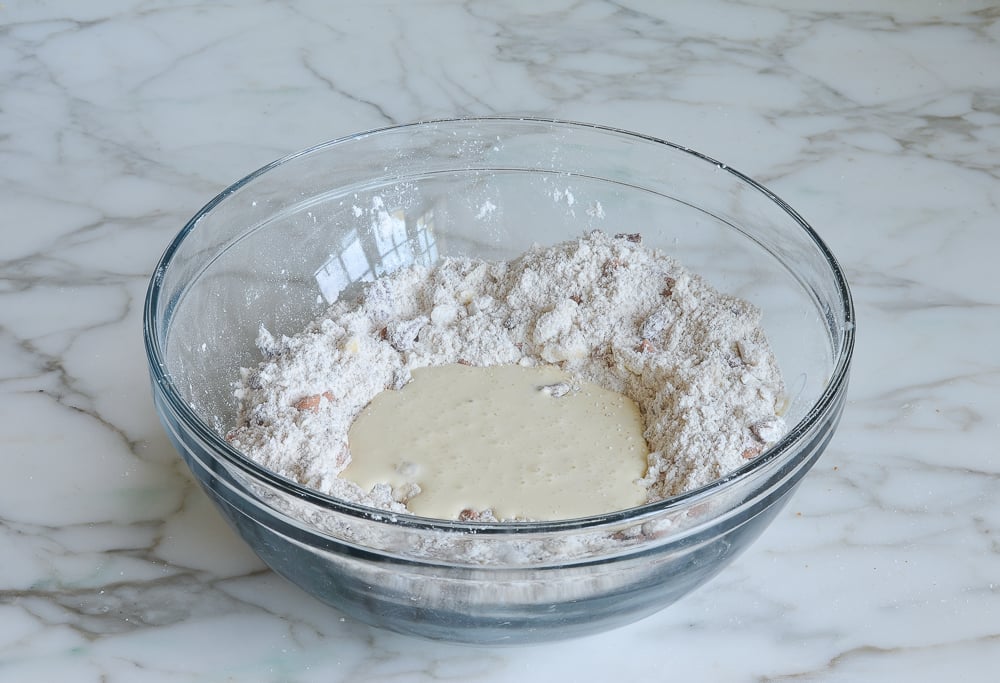 Bowl with dry ingredients and heavy cream mixture.
