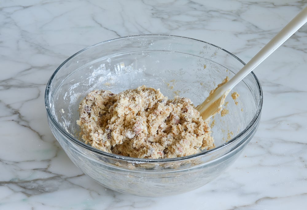 Rubber spatula in a bowl of dough.
