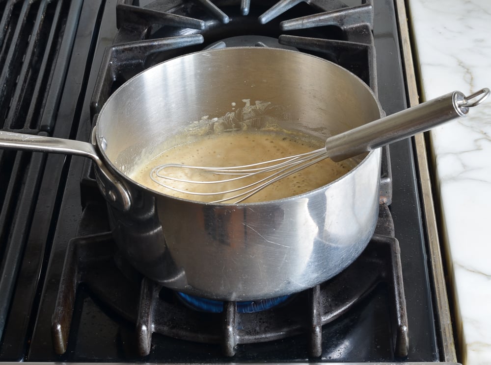 Whisk in a pot of flour and butter.