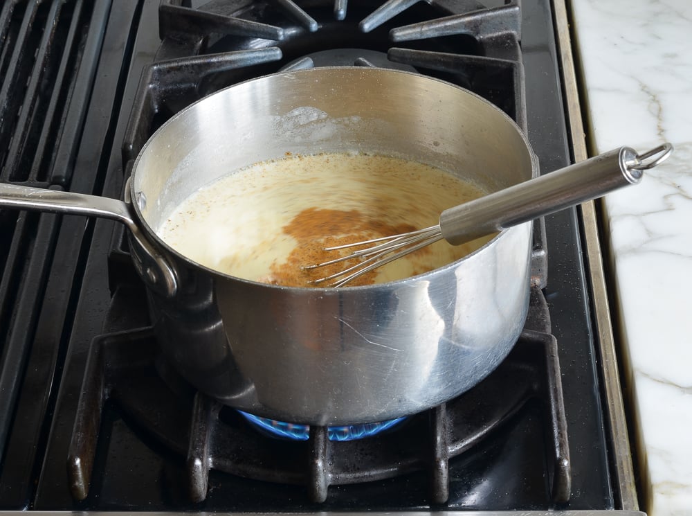 Seasonings in a pot with half and half.