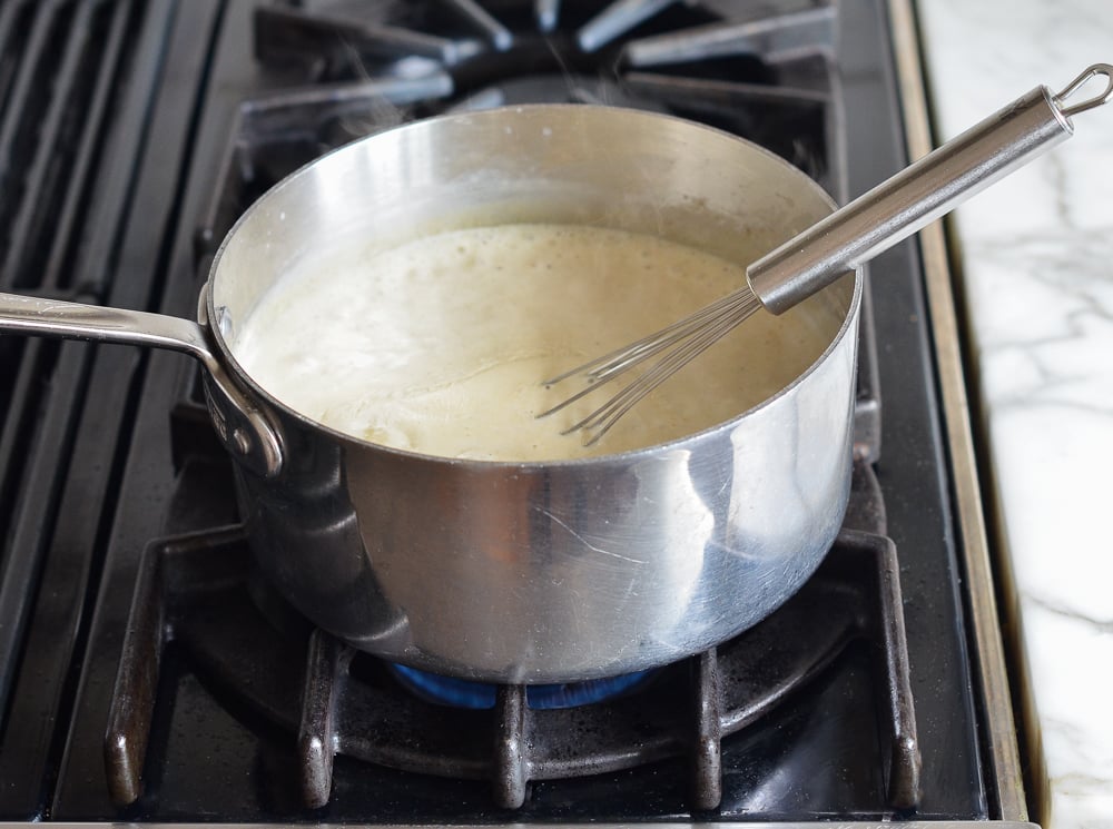 Whisk in a pot of thickened half and half with seasonings.
