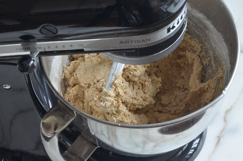 Cookie dough in a stand mixer.