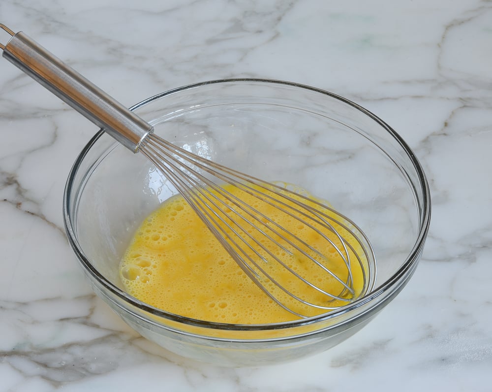 whisking eggs in mixing bowl