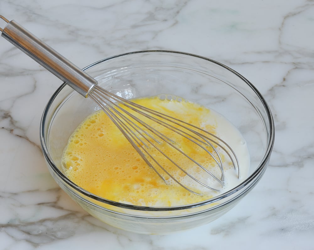 whisking the milk into the eggs
