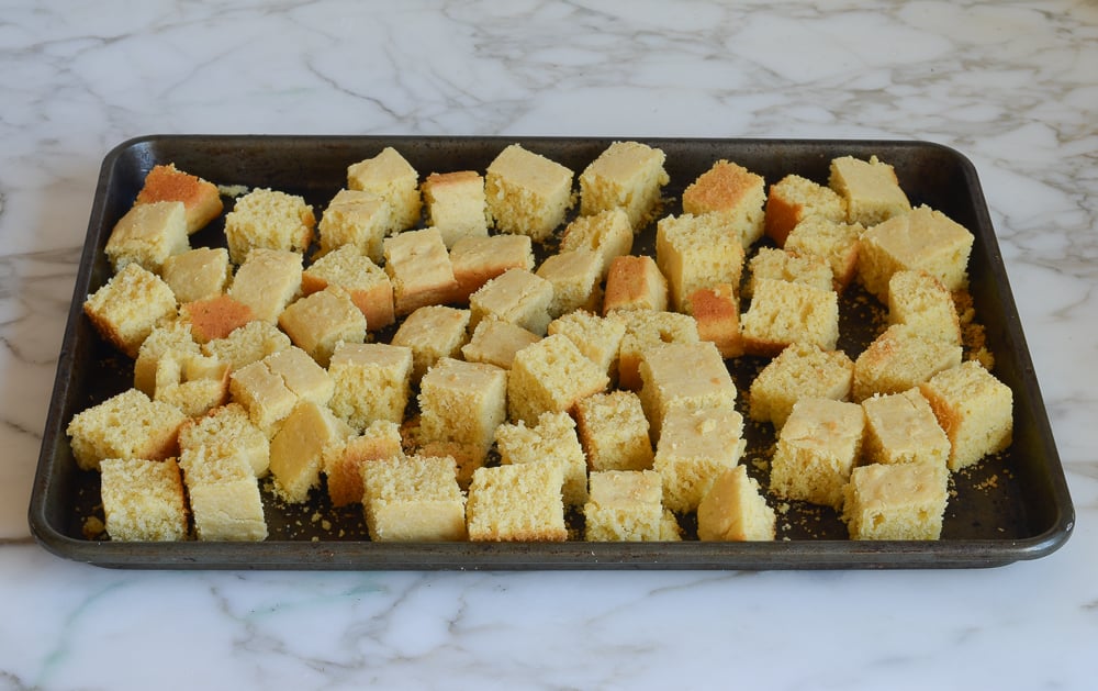 cubes of cornbread on baking sheet