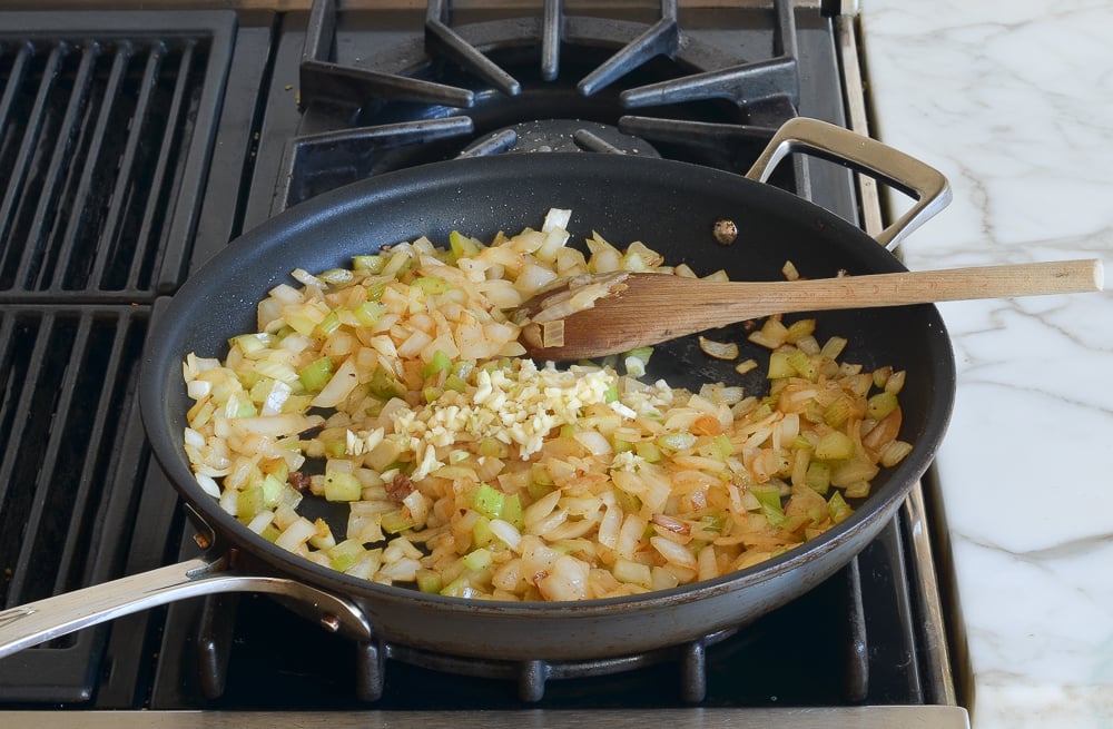 adding the garlic to the vegetables
