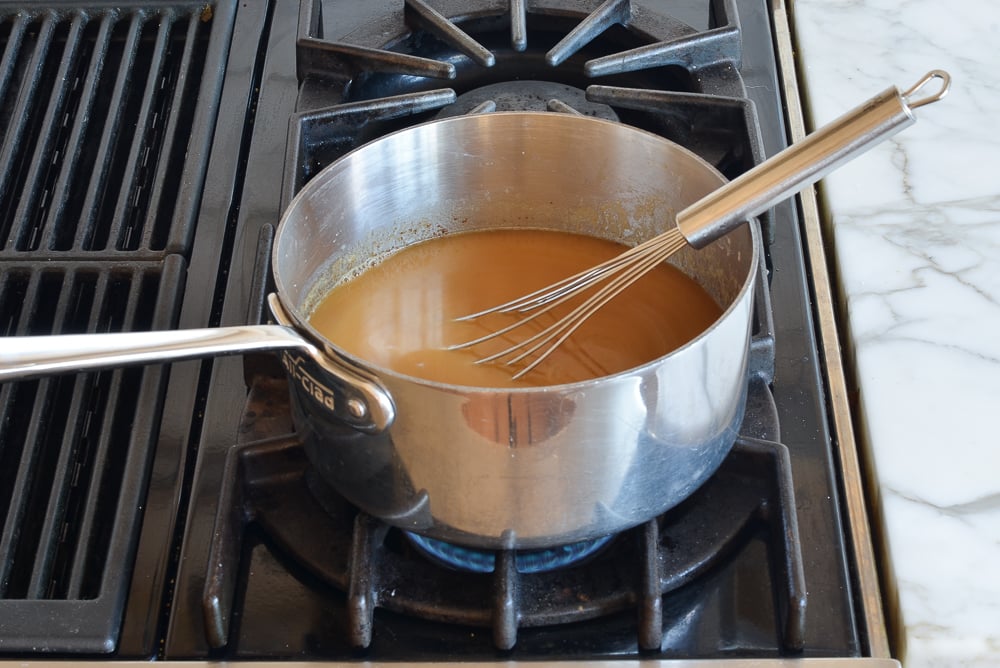 Whisk in a sauce pan of brown liquid.