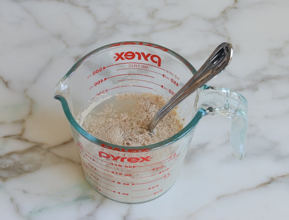 Measuring cup of yeast in water.