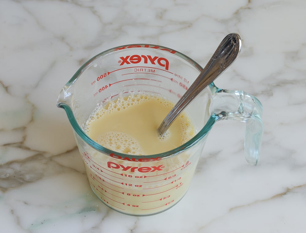 Egg and yeast mixture in a measuring cup.