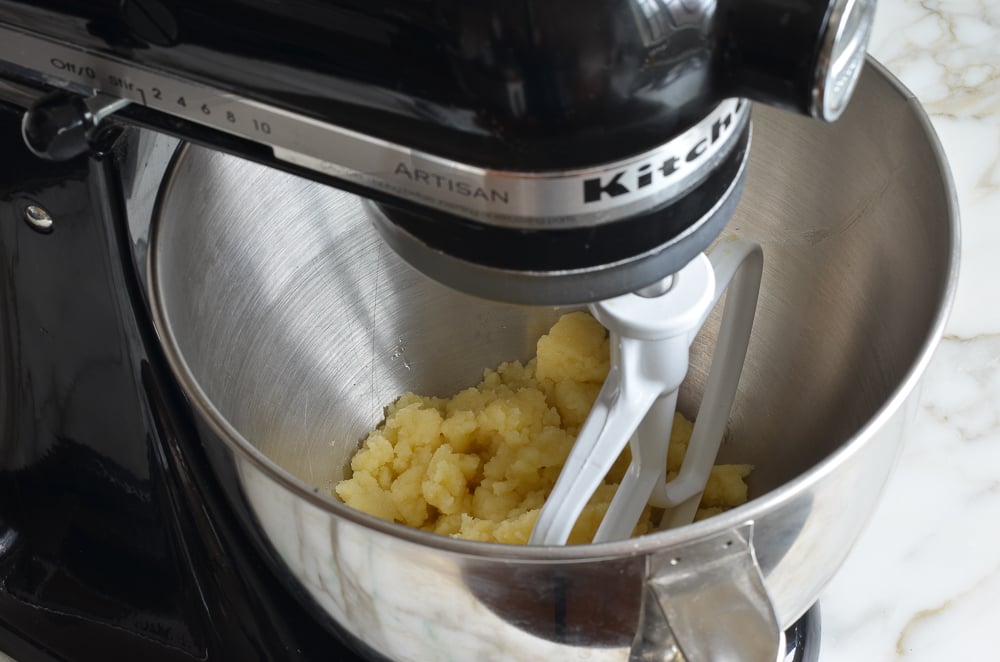 Dough in the bowl of a stand mixer.
