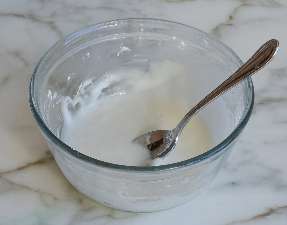 Spoon in a bowl of glaze.