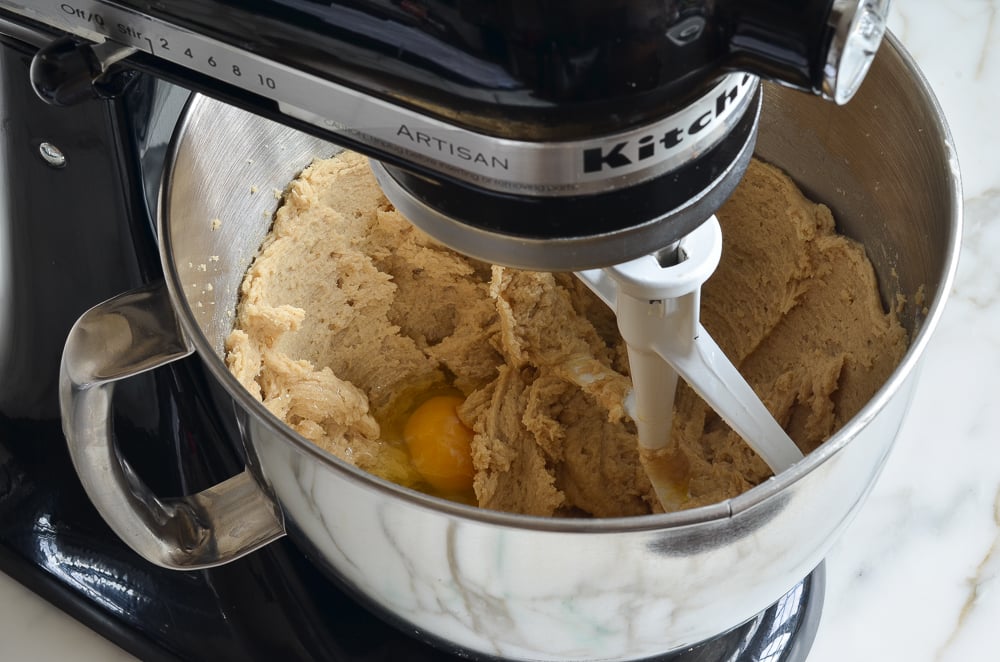 Egg in a stand mixer with a butter mixture.