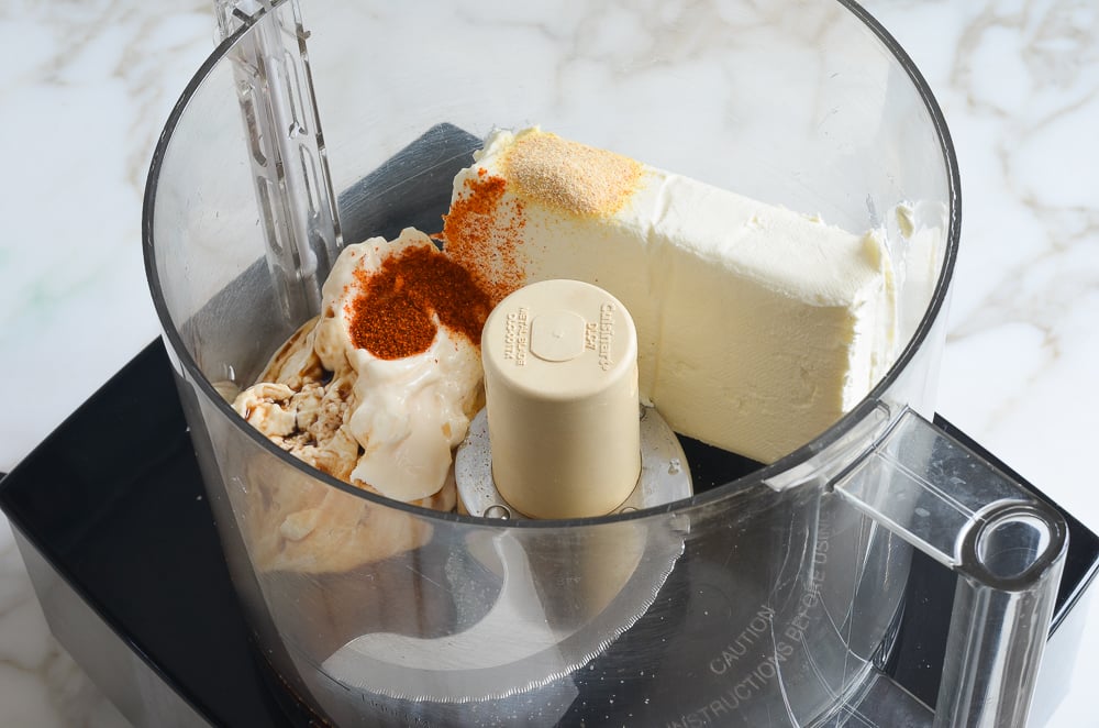 Cream cheese, seasonings, and other ingredients in a food processor.